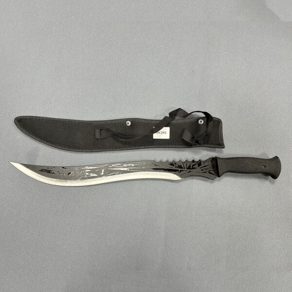 ​​Full tang machete with long curved blade featuring serrated back edge and textured black handle alongside fabric sheath with carrying strap