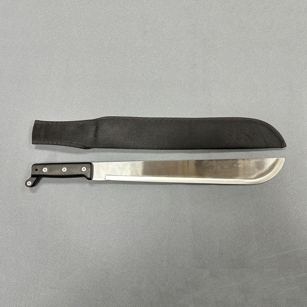 Single-edged machete with curved metal blade and black handle alongside fabric sheath with strap on solid surface