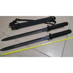Two black swords with textured grips and hole-pierced blade alongside sheath on light-tile floor - Yellow tape shows length